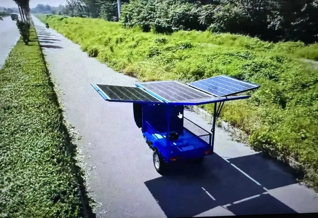 rider-cleaning-solar-tricycle-panels